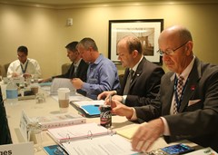 Clark Teuscher of North Central College (second from right) giving a Continuing Educations committee report.